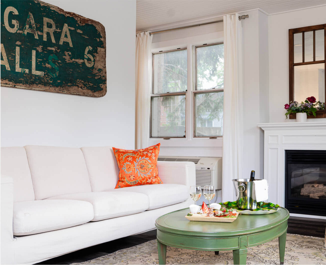 A white couch with a coffee table at The Kent Motel